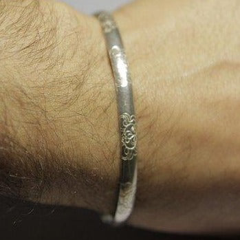 Rigid bracelet decorated in silver