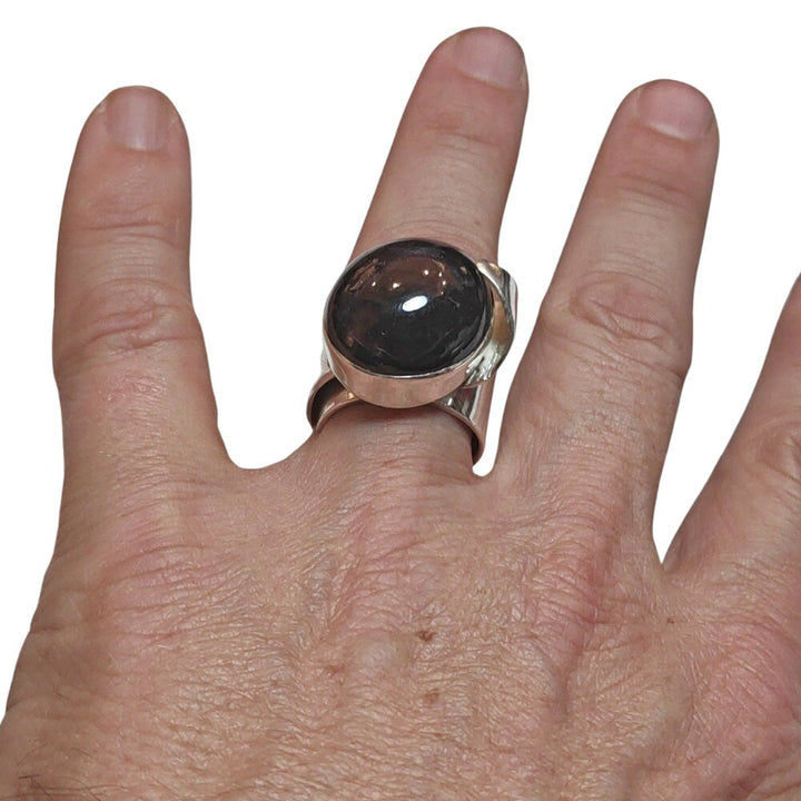 ANELLO con granato stellato e argento su mano